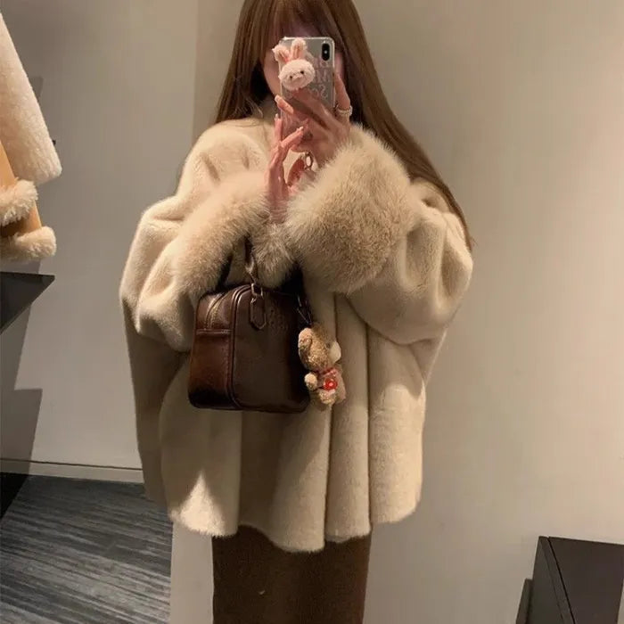 womens faux fur coat styled oversized with plush cuffs and handbag creating a chic winter outfit with premium warmth appeal