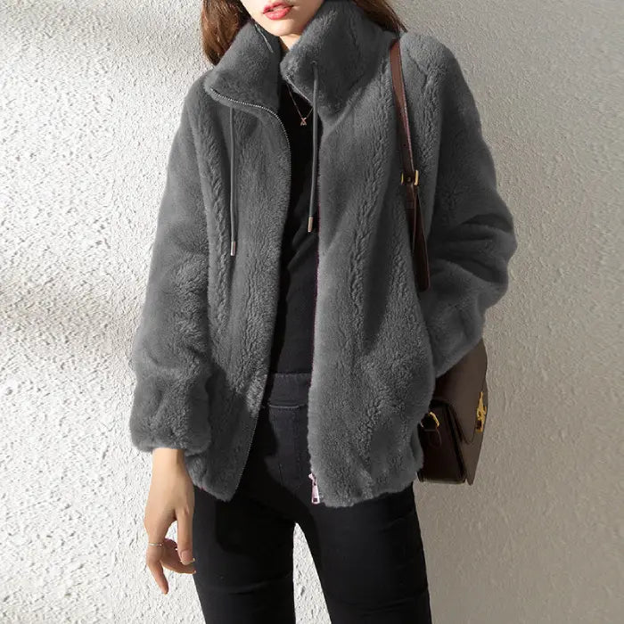 women’s faux fur jacket in grey styled with black outfit for a warm look