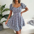  Women's flower print mini dress in blue with short puff sleeves and sweetheart neckline.