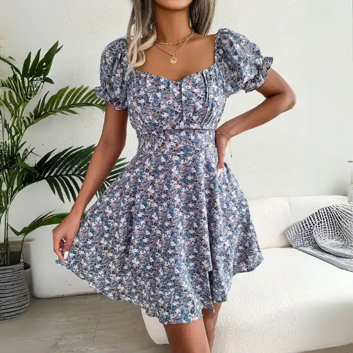  Women's flower print mini dress in blue with short puff sleeves and sweetheart neckline.