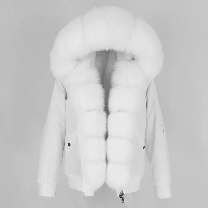 Womens fox fur parka with oversized hood in all white, showcasing plush fluffy trim and elegant winter styling for warm seasonal wear