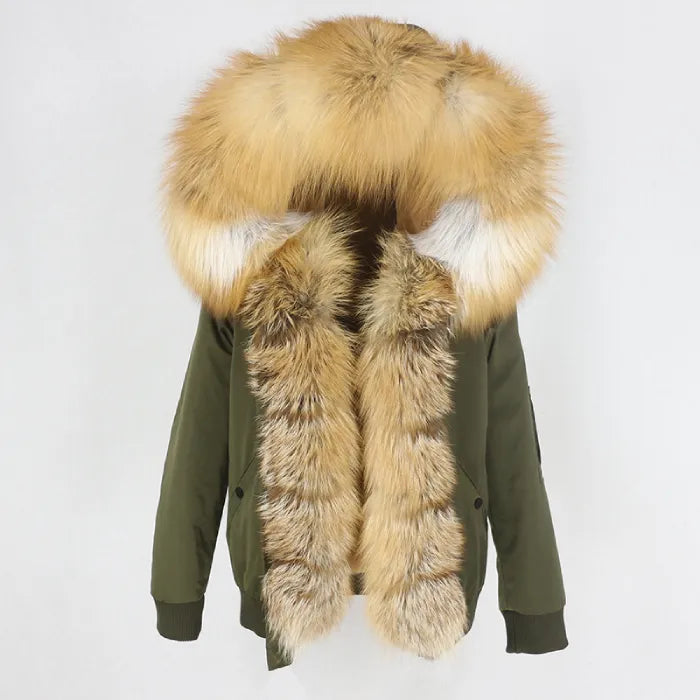 Womens fox fur parka with oversized hood in army green with golden trim, blending rugged style with luxurious warm detailing