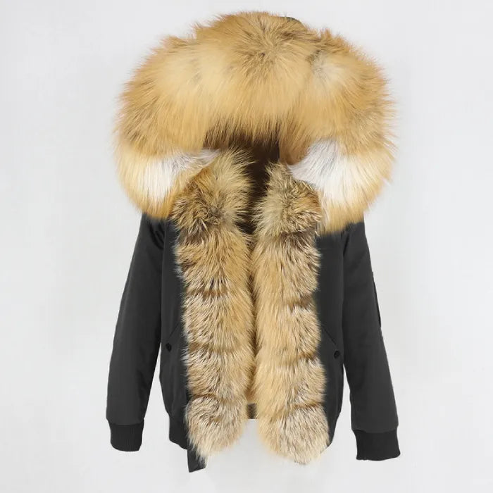 Womens fox fur parka with oversized hood in black with golden trim, offering rich contrast and plush warmth for winter dressing