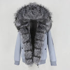 Womens fox fur parka with oversized hood in light blue with silver trim, highlighting plush texture and stylish cozy winter wear