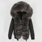 Womens fox fur parka with oversized hood in black with dark silver trim, offering plush texture and premium winter warmth