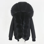 Womens fox fur parka with oversized hood in deep black, showcasing rich fluffy trim and elegant winter design for cozy comfort
