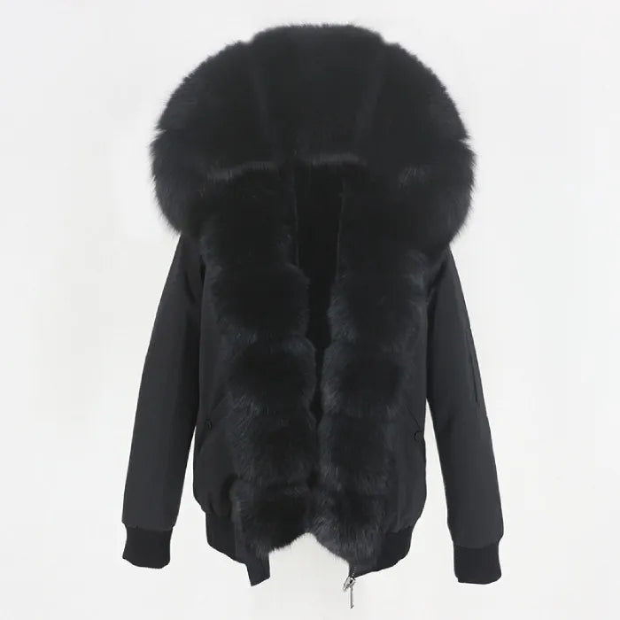 Womens fox fur parka with oversized hood in deep black, showcasing rich fluffy trim and elegant winter design for cozy comfort
