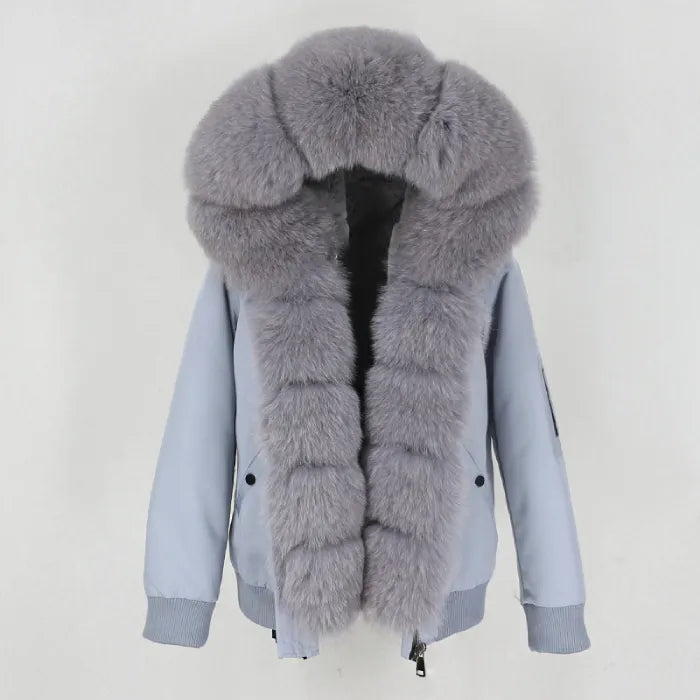 Womens fox fur parka with oversized hood in soft grey, featuring plush thick trim and luxury winter styling for added warmth