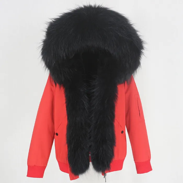 Womens fox fur parka with oversized hood in bold red with black trim, offering dramatic contrast and premium warmth for winter