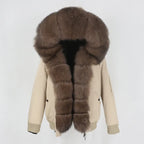 Womens fox fur parka with oversized hood in taupe with chocolate brown trim, adding rich warmth and elegant winter styling