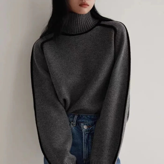 Women's Half Turtleneck Sweater in dark grey with black piping, paired with blue jeans for casual wear.