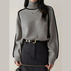 Women's Half Turtleneck Sweater in grey styled with a high-waisted belted skirt and chain strap accessory.