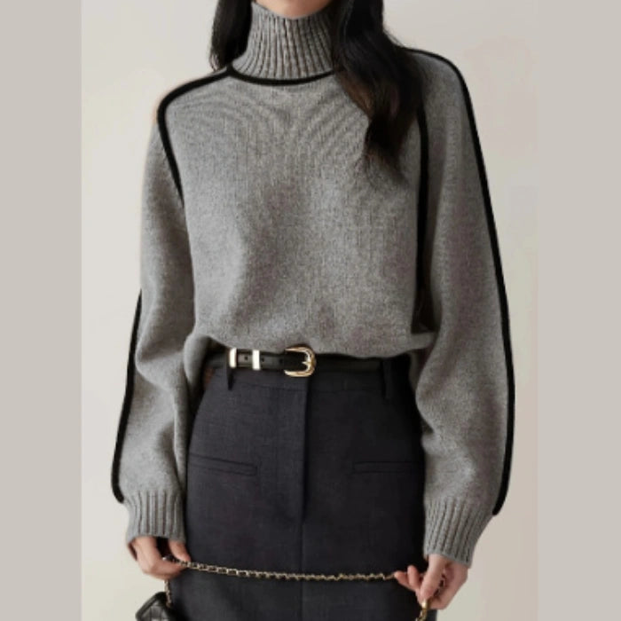 Women's Half Turtleneck Sweater in grey styled with a high-waisted belted skirt and chain strap accessory.