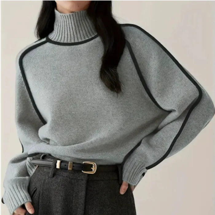 Women's Half Turtleneck Sweater in light grey with dark trim and ribbed neck, styled with belted trousers.