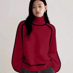 Women's Half Turtleneck Sweater in bold red with black piping details and ribbed cuffs and hem.