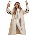 Women’s long hooded cardigan coat in beige as model takes selfie, cozy knit sleeves adding warm trendy style for modern winter outfits