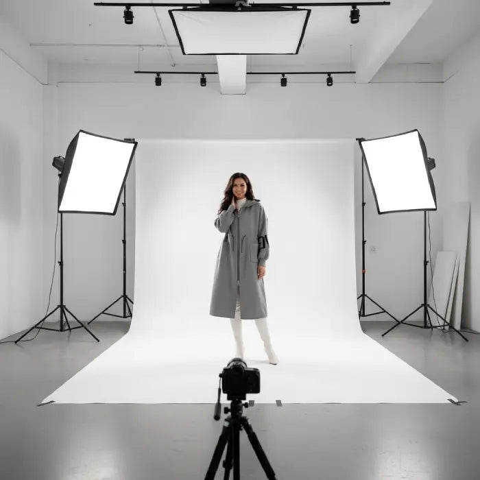 Women’s long hooded cardigan coat in grey modeled in bright studio, soft knit sleeves providing warm minimalist comfort for daily wear