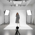 Women’s long hooded cardigan coat in grey modeled in bright studio, soft knit sleeves providing warm minimalist comfort for daily wear