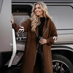 Women’s long hooded cardigan coat in rich brown worn beside vehicle, cozy knit sleeves adding warm luxury style for modern fall outfits
