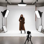 Women’s long hooded cardigan coat in rich brown worn beside vehicle, cozy knit sleeves adding warm luxury style for modern fall outfits