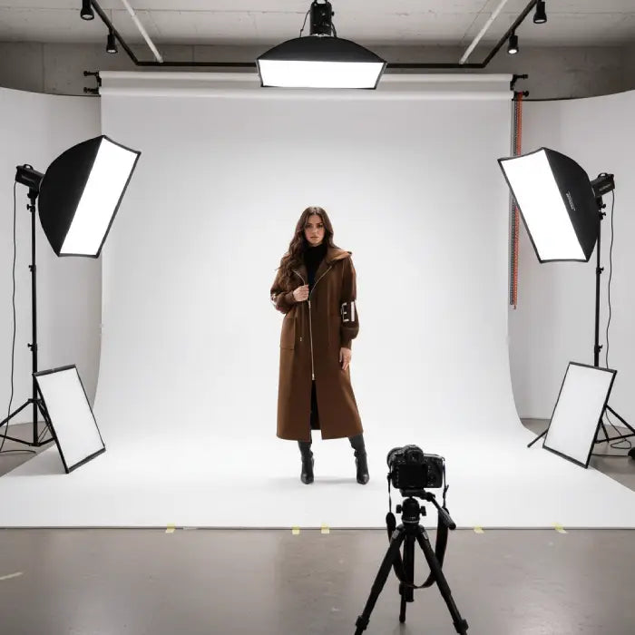 Women’s long hooded cardigan coat in rich brown worn beside vehicle, cozy knit sleeves adding warm luxury style for modern fall outfits