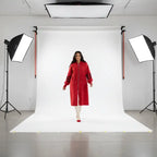 Women’s long hooded cardigan coat in bold red modeled in studio, knit sleeves adding warm comfort and standout color for seasonal style