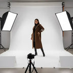Women’s long hooded cardigan coat in black styled outdoors near vehicle, sleek knit sleeves offering elegant modern outerwear comfort