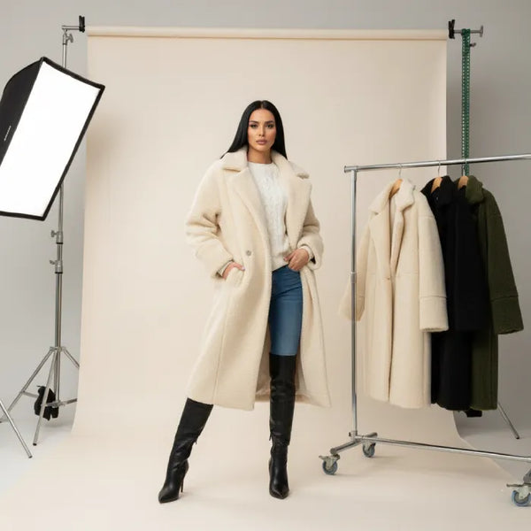 women's long oversized coat worn in soft cream tone with straight silhouette ideal for timeless cold weather styling