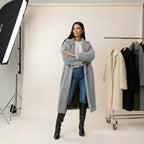women's long oversized coat in grey wool worn with jeans and boots delivering modern warmth and everyday elegance
