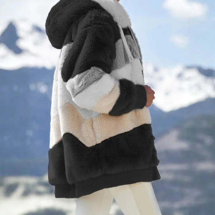 Womens loose plush striped fur hoodie in neutral tones worn outdoors.