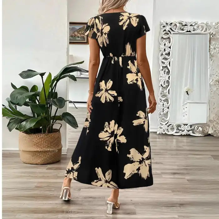 Women's midi dress with short sleeves and elastic waist, featuring beige floral print on black background.