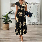 Women's midi dress with v-neck and beige floral accents styled for an elegant evening or casual event.
