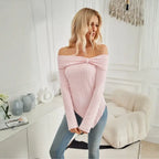Close front view of women's off shoulder knit top in pink with ribbed texture and knotted neckline.