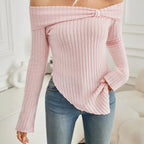 Pink ribbed off-shoulder top worn with blue jeans on a white background