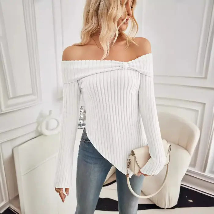 Full view of women's white off shoulder knit top paired with skinny jeans and casual sneakers.