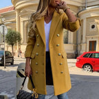 Womens Overcoat in mustard color with gold buttons, styled with jeans and printed handbag.