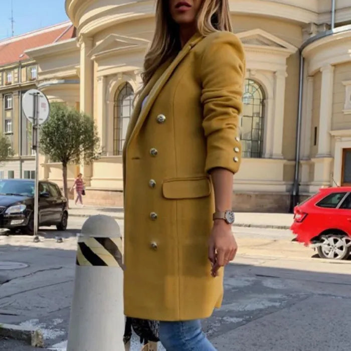 Womens Overcoat in mustard yellow featuring gold buttons and slim-fit design, worn outdoors with jeans.