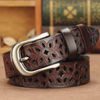 women's patterned belt in carved brown leather with floral cutout and silver buckle