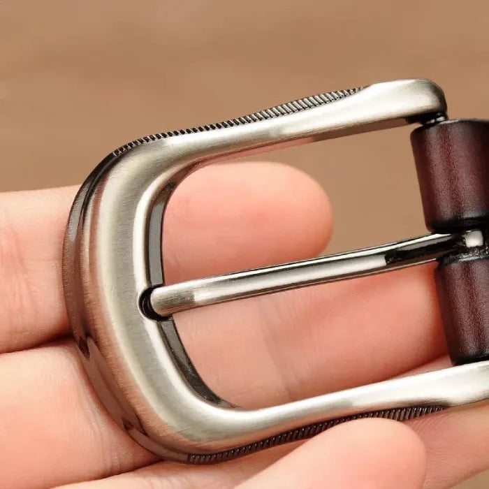 women's patterned belt metal buckle shown in closeup highlighting brushed finish