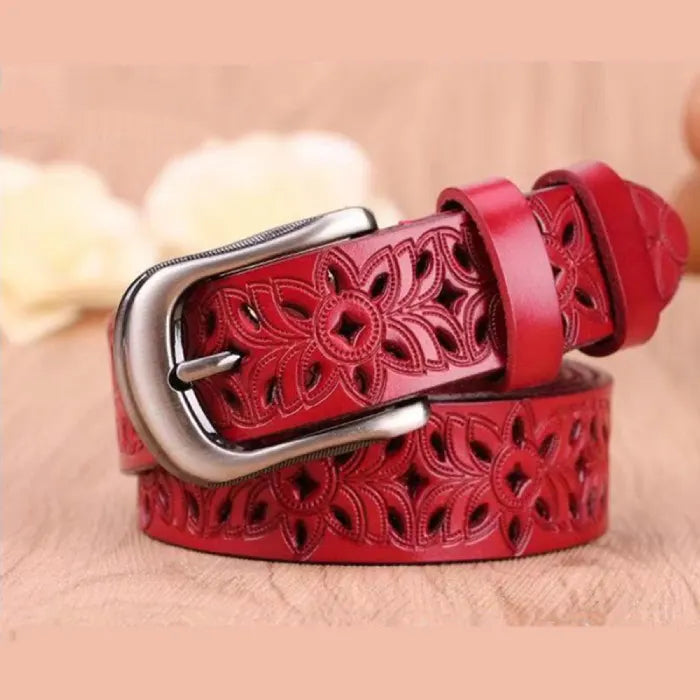 women's patterned belt in red leather with floral cutout design and metal buckle