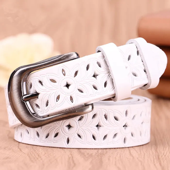 women's patterned belt in white leather featuring floral cutout pattern and silver buckle