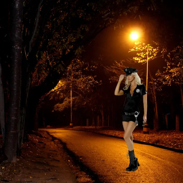 Women's police officer costume styled in a dimly lit park with trees and glowing lampposts.