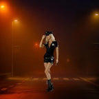 Women's police officer costume shown on foggy street at night under orange streetlights.