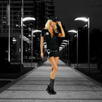 Women's police officer costume styled outdoors on a paved walkway with modern buildings and lights.