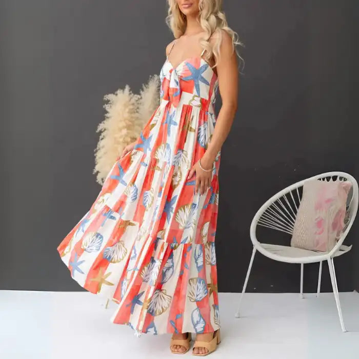  Women's printed spaghetti strap maxi dress with pockets and flared tiered skirt in coastal design.