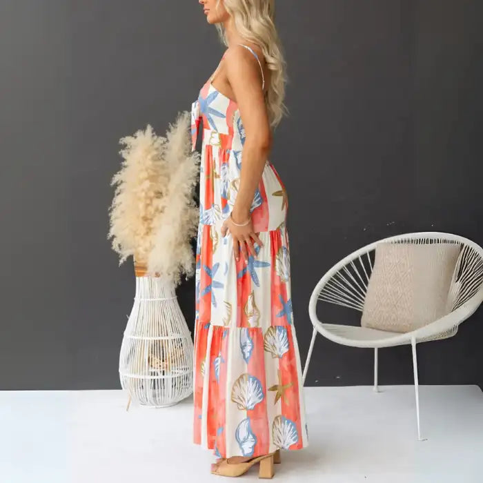  Women's printed spaghetti strap maxi dress shown from the side with seashell and coral pattern.