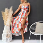  Women's printed spaghetti strap maxi dress with slit, flowy hem, and sea-themed pattern.