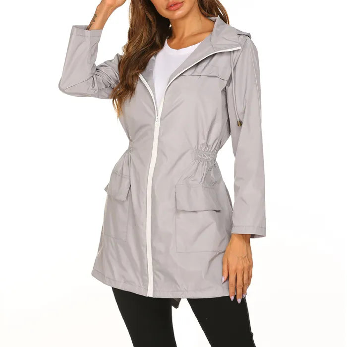 Womens raincoat in gray with adjustable waist and front pockets.