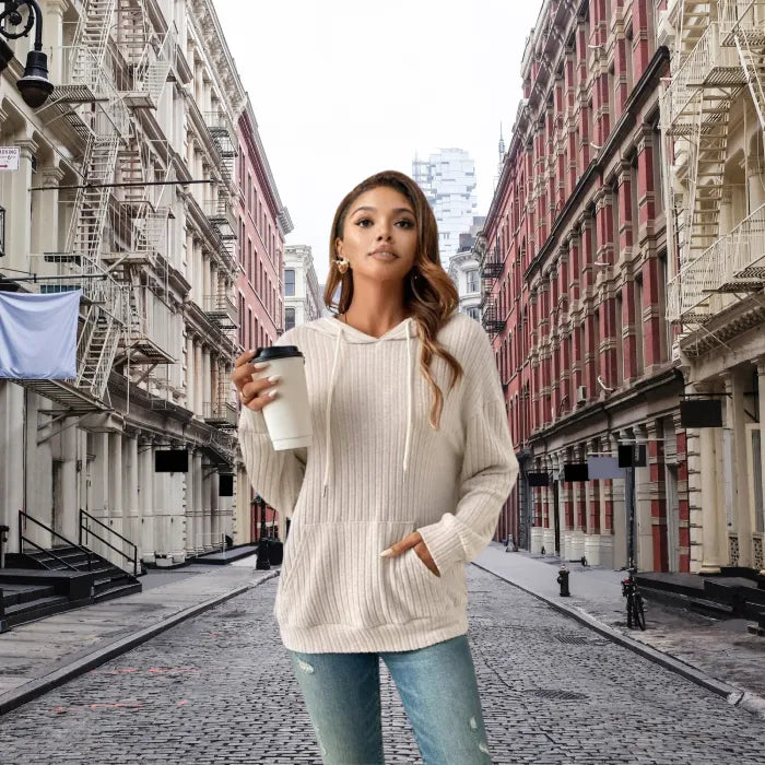 Women's Ribbed Hoodie styled for a casual coffee run on a cobblestone street in the city.