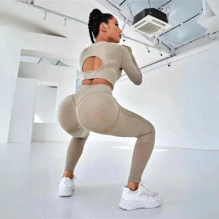 Women's seamless butt-lifting sportswear sets in beige with high-waist leggings and crop-back detail.